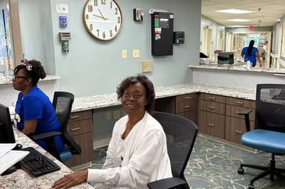 Staff member at a reception desk in the facility
