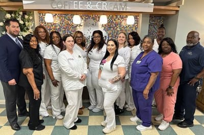 Staff members posing together in a common area