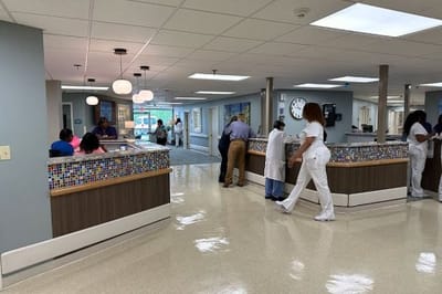 Bright interior of a nursing home lobby with staff and residents