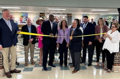 Ribbon-cutting ceremony with staff and community members