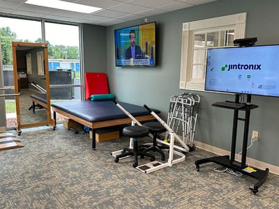 Rehabilitation therapy room with equipment and a television