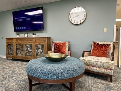 Comfortable seating area with a decorative clock and TV