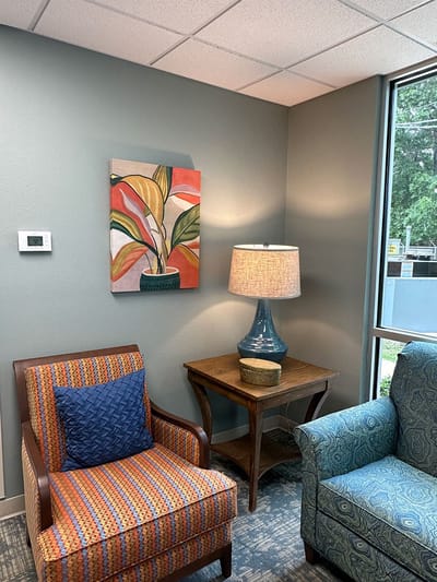 Cozy lounge area with chairs and artwork
