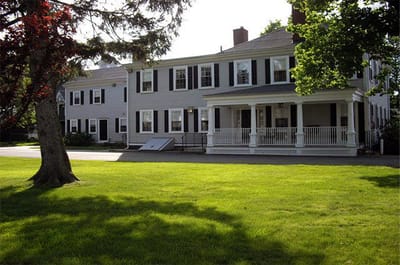 Exterior view of a nursing home building surrounded by lawn
