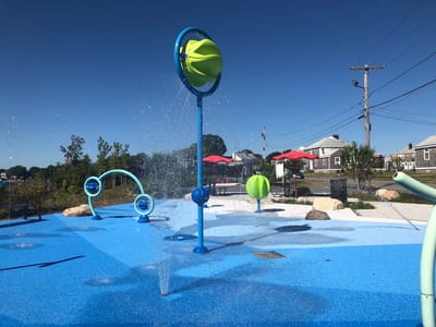 Outdoor splash pad area with bright colorful water features