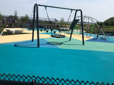 Colorful outdoor playground with swings and climbing structures