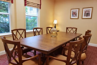 Common area with a large wooden table and chairs