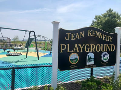 Outdoor playground with swings and colorful flooring