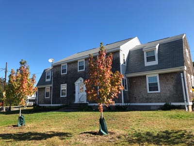 Exterior view of a senior living facility with autumn trees