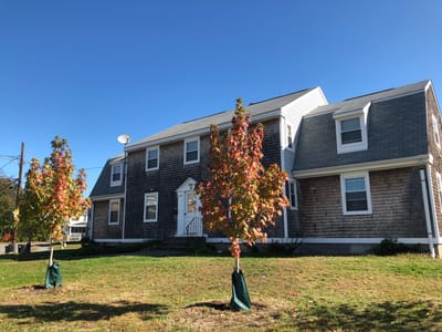 Exterior view of a senior living facility with autumn trees