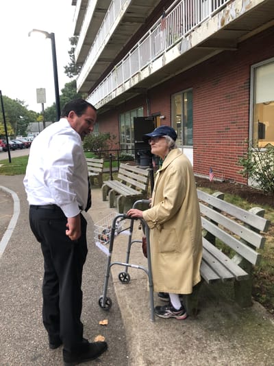 Staff member conversing with a resident outdoors