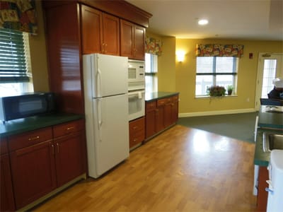 Bright kitchen area with cabinets and appliances