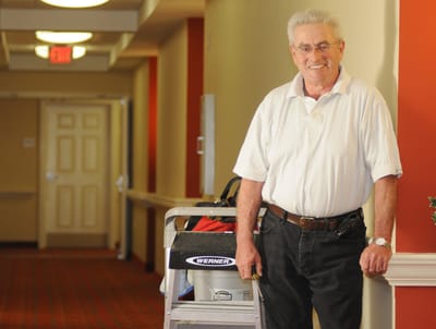 Staff member posing in a facility hallway