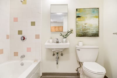 Bright and clean bathroom with tub and sink
