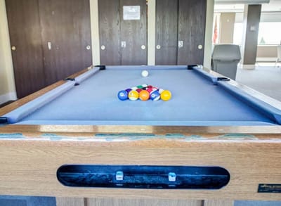 A pool table set up for a game in a communal area