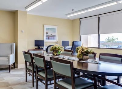Bright common area with dining tables and decor