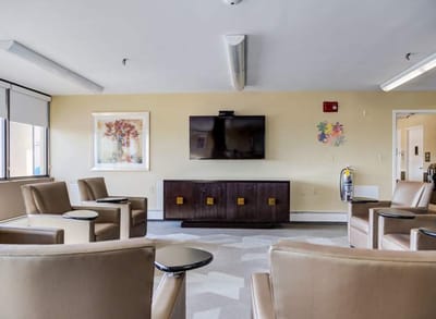 Bright common area with seating and a TV