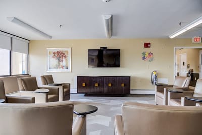 Bright common area with comfortable seating and TV