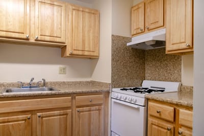 Kitchen area with wooden cabinets and stove