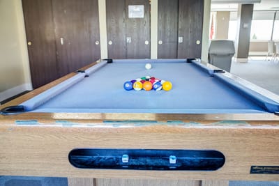 A pool table set up for play in a social area