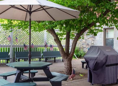 Outdoor patio with seating and grill