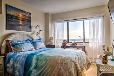 Cozy bedroom with a scenic view.