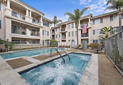 Pool area with seating and palm trees