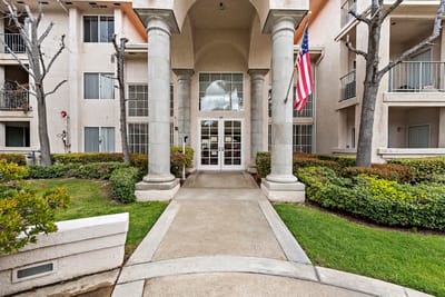 Entrance of Palacio Senior Apartments with landscaping