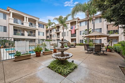 Outdoor patio area with a fountain and seating