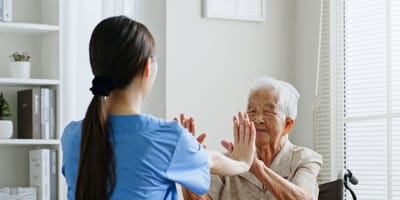Staff member interacting with a resident in an activity.