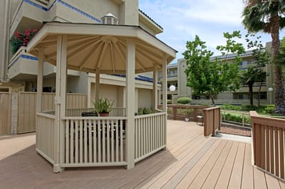 An outdoor gazebo surrounded by greenery
