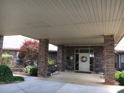Entrance of an assisted living facility with greenery