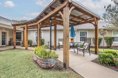 Outdoor seating area with pergola and garden