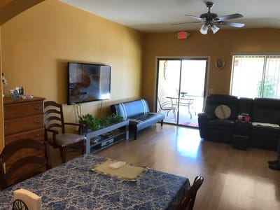 Common area with seating and sliding door to patio
