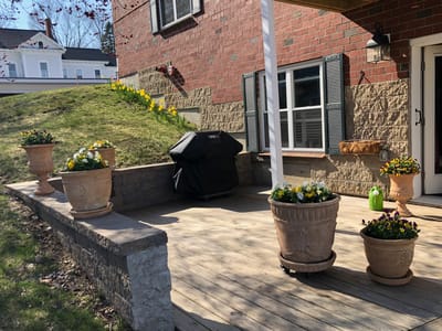 Outdoor patio with flowers and a grill