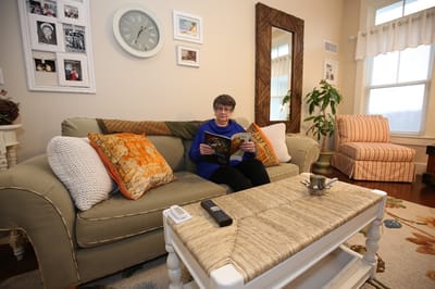 Resident reading in cozy living room