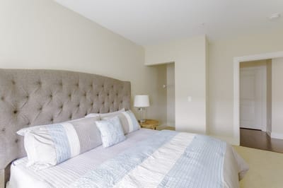 Cozy bedroom with a tufted headboard and lamp