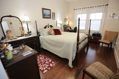 A cozy resident bedroom with warm lighting.