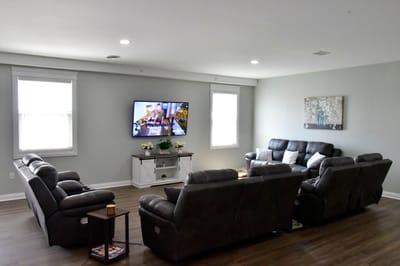 Common area with seating and television in a senior living facility