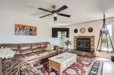 A cozy common area with a sofa and fireplace
