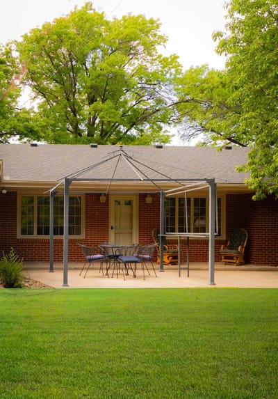 Outdoor patio area with seating and a view of the home