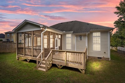 Exterior view of a house with a deck and yard