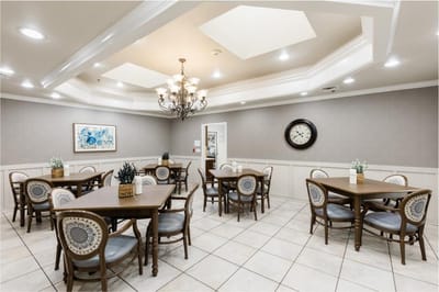 Dining area with multiple tables and a chandelier