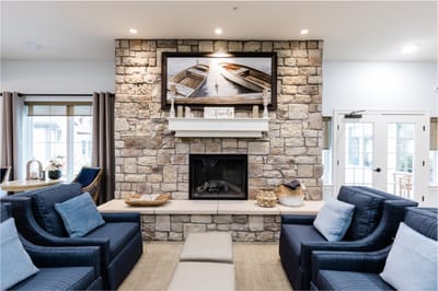 Cozy lounge area with stone fireplace and seating