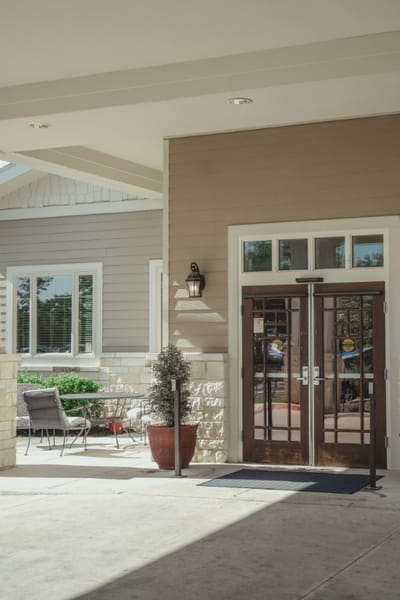 Entrance of Grand Brook Memory Care facility with seating area