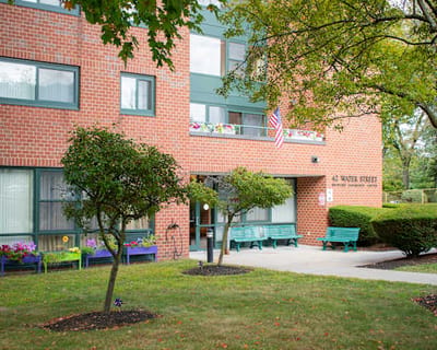 Exterior view of Water Street Apartments with landscaping.