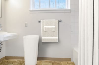 Clean, simple bathroom with white towels