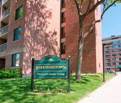 Exterior view of a senior living facility sign.