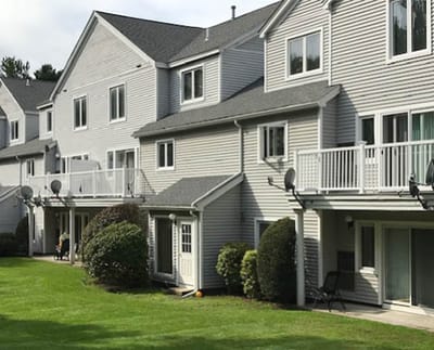Exterior view of residential units with lawn.