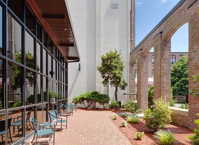 Outdoor patio area with benches and landscaping.